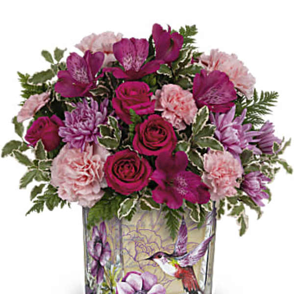 Pink and purple mixed bouquet in a square glass vase