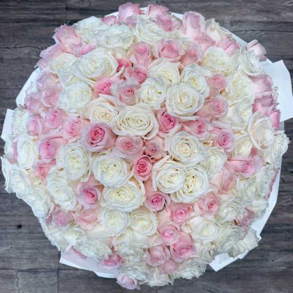 Round bouquet of white and pale pink roses