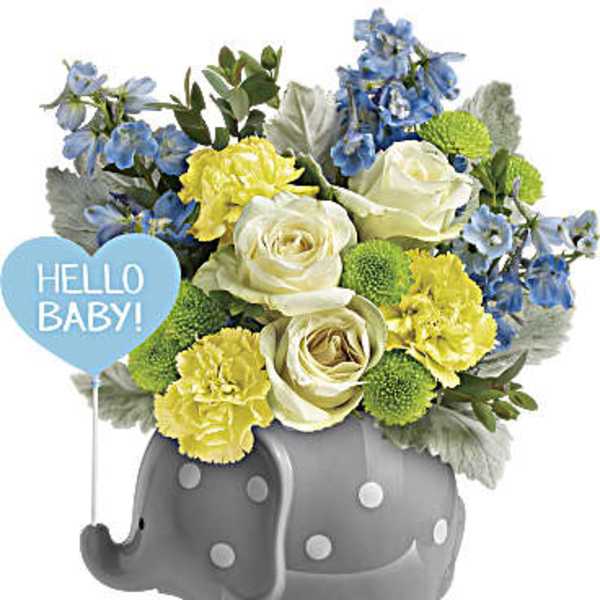 Blue and yellow flower arrangement in a gray elephant planter with a Hello Baby sign