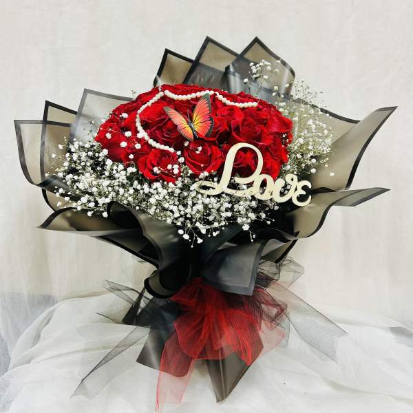 Red rose bouquet with baby's breath, pearl garland, and a Love sign