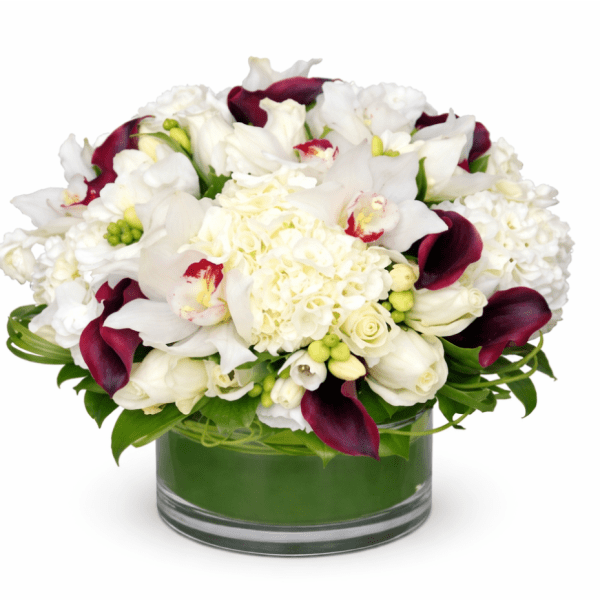 White and burgundy floral arrangement in a glass vase