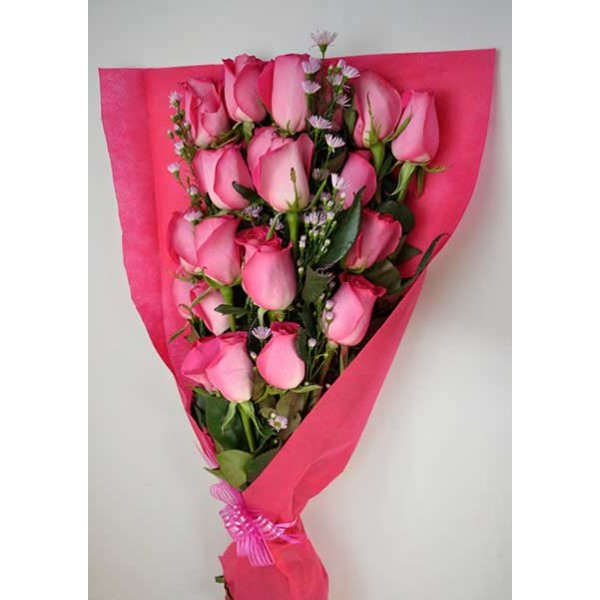 Bouquet of pink roses wrapped in bright pink paper