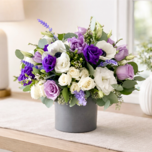 Purple and white bouquet in a gray vase