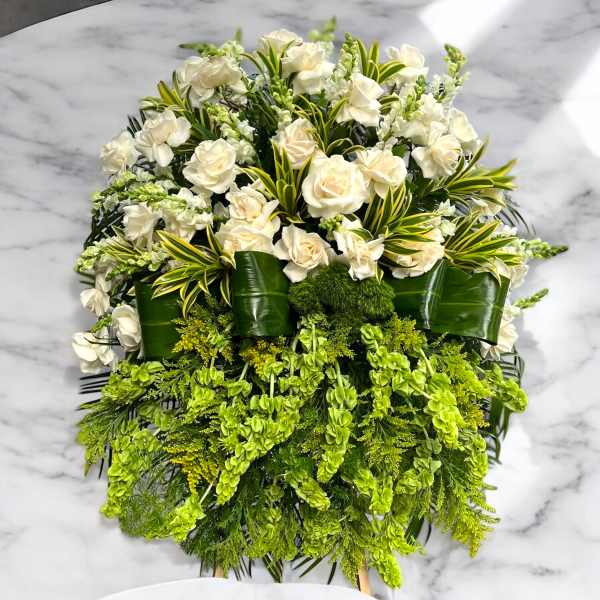 White roses and green flowers in a cascading arrangement