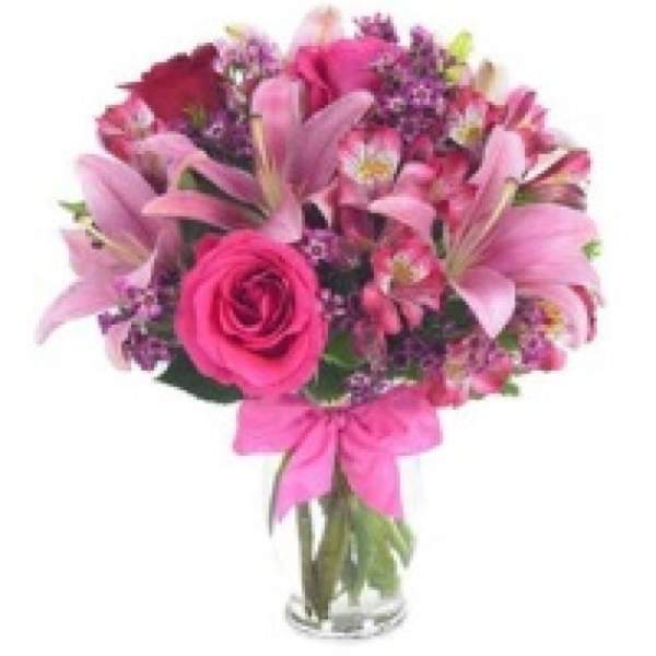 Pink bouquet with lilies and roses in a glass vase