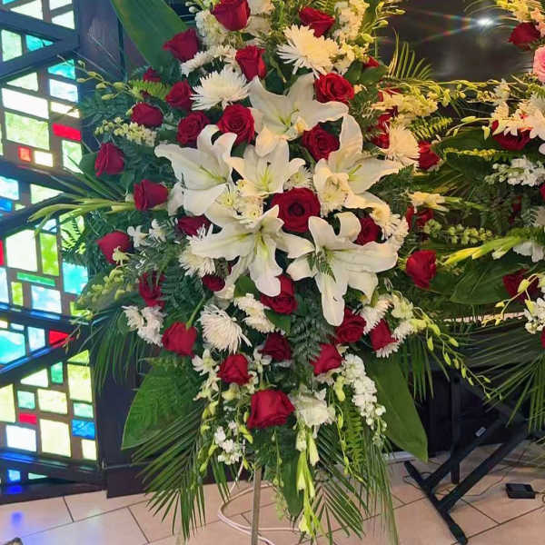 Large standing floral spray with red roses and white lilies
