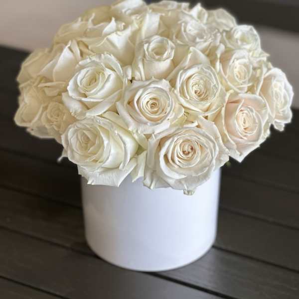 White rose bouquet in a white cylindrical vase