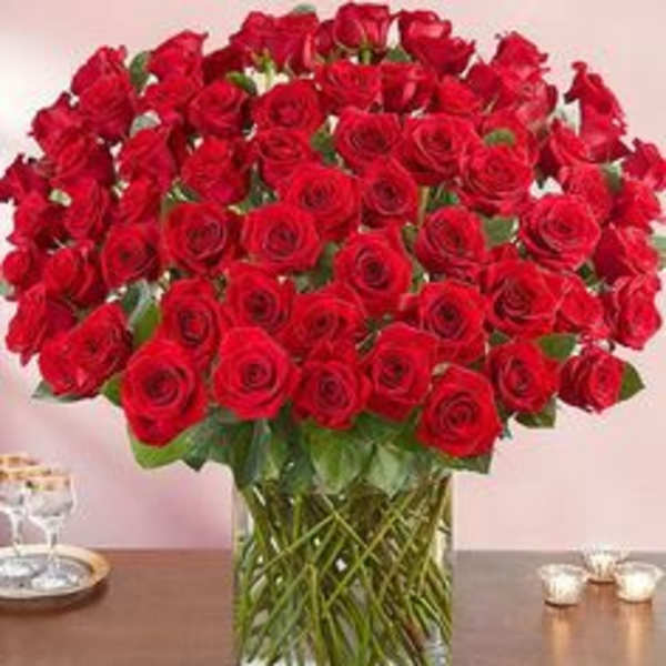 Large bouquet of red roses in a clear glass vase