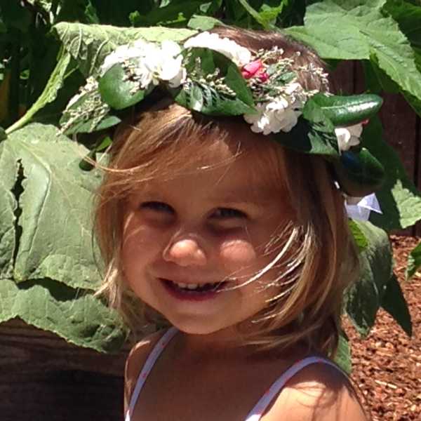 Child wearing a flower crown outdoors