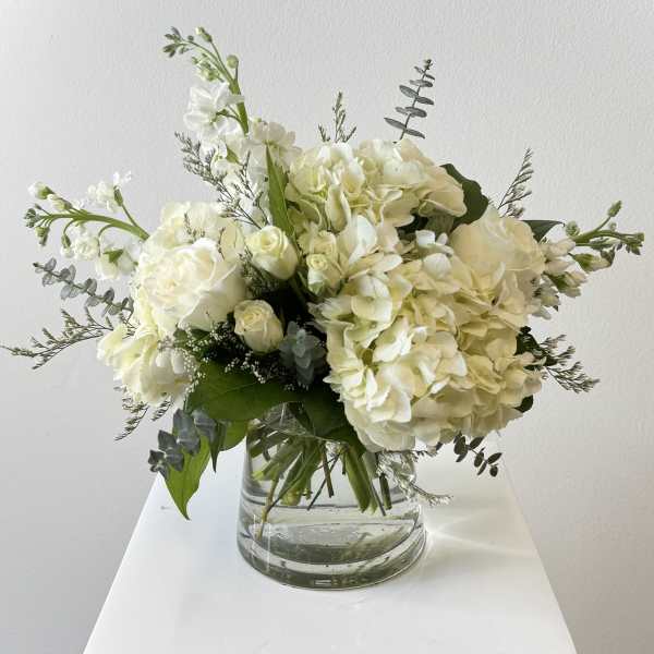 White floral bouquet in a clear glass vase