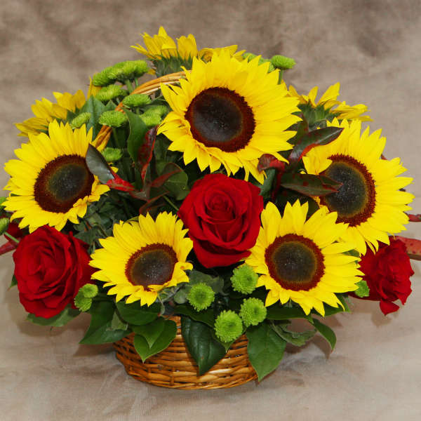 Basket arrangement of sunflowers and red roses