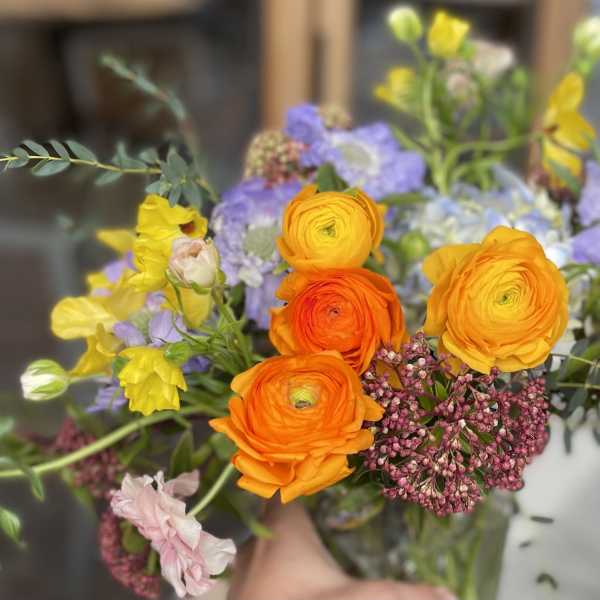Bouquet of orange, yellow, and lavender flowers