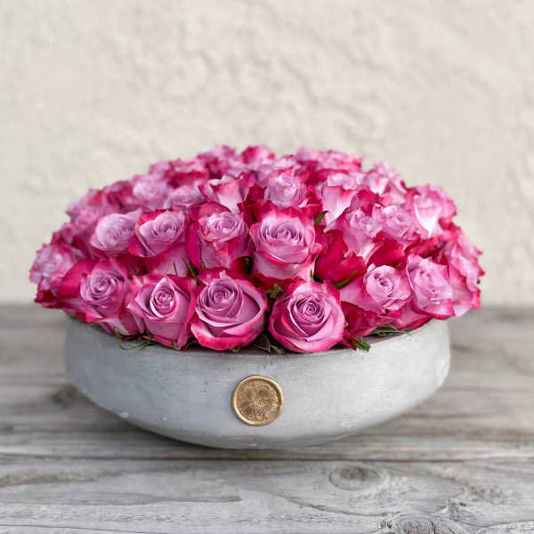Round box filled with pink roses