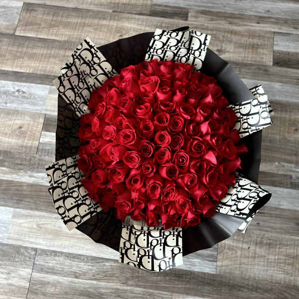 Large bouquet of red roses wrapped in black and white paper