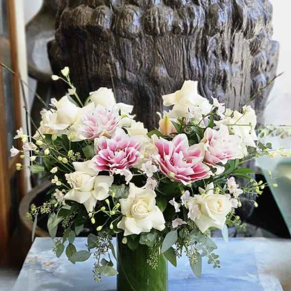 Pink and white floral arrangement in a glass vase