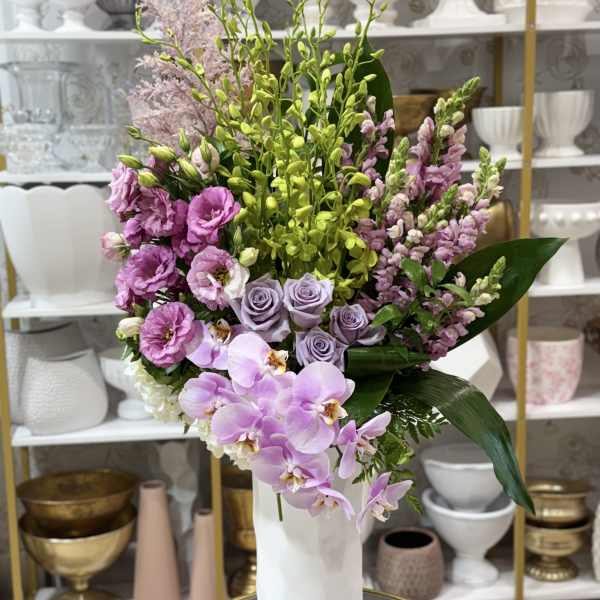 Lavender and pink floral arrangement in a white vase