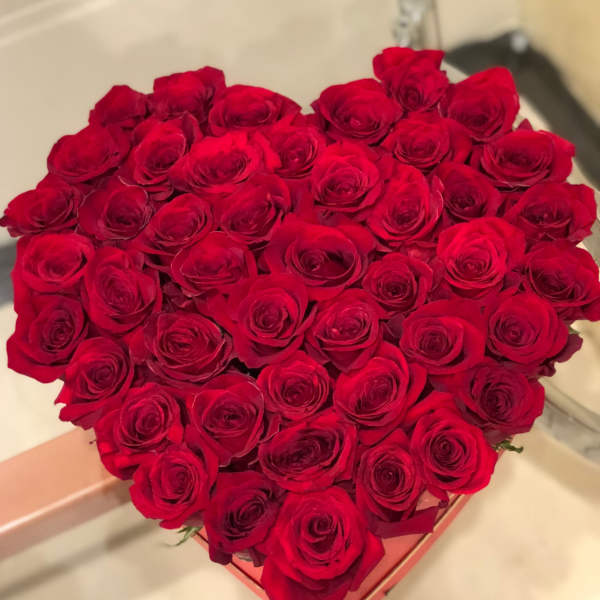 Heart-shaped box filled with red roses