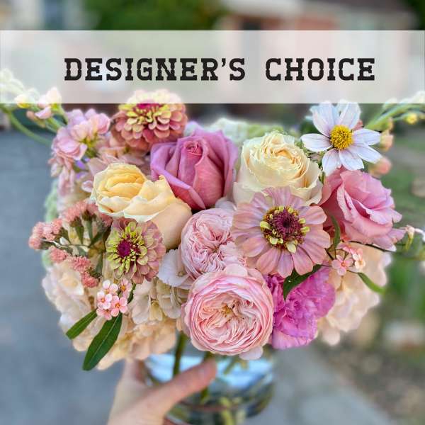 Pastel bouquet of roses and mixed blooms in a glass vase