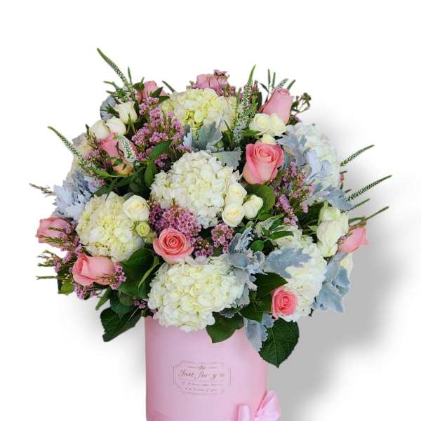 Pink and white rose bouquet in a pink hatbox with a ribbon