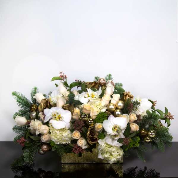 White orchids and cream roses arranged in a gold box with ornaments