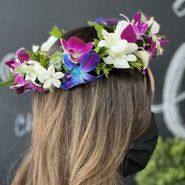Flower crown with white and magenta orchids on a woman's head