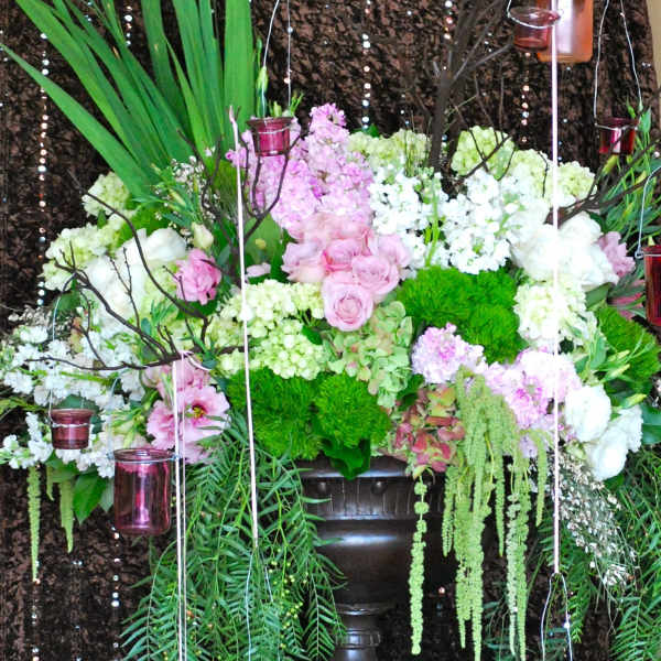 Large floral arrangement with pink and white blooms on a pedestal