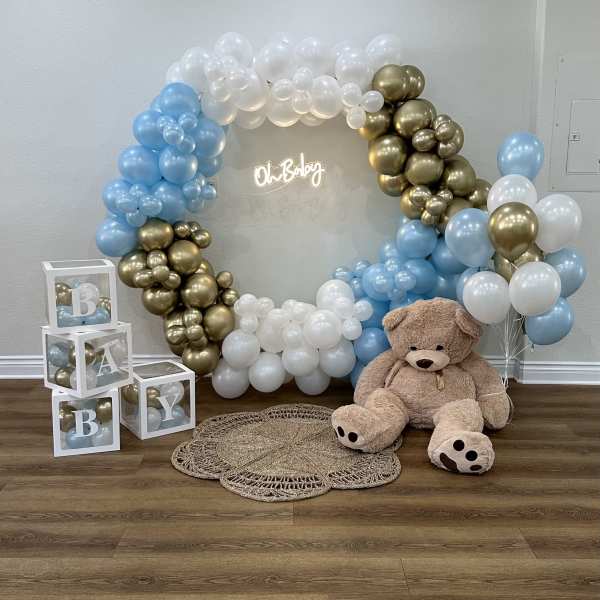 Baby shower balloon arch with teddy bear and letter blocks