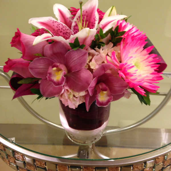 Pink and white mixed flower arrangement in a glass vase