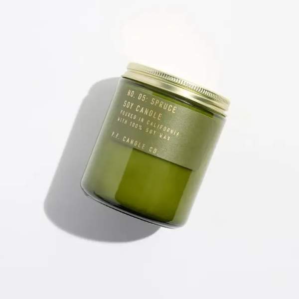 Green soy candle in a glass jar with a metal lid