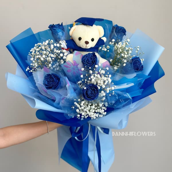 Blue bouquet with a teddy bear and white baby's breath