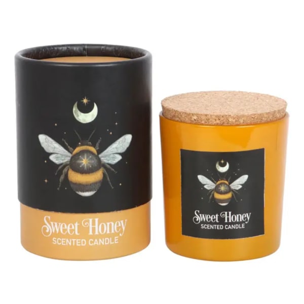 Two scented candles in amber jars with bee labels and cork lids