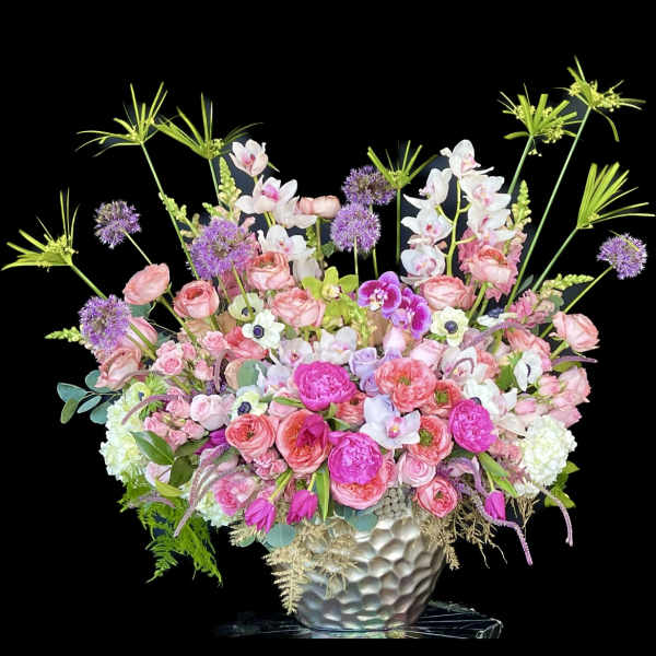 Pink and white mixed flower arrangement in a silver vase