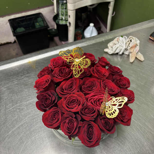 Round bouquet of red roses with gold butterfly picks
