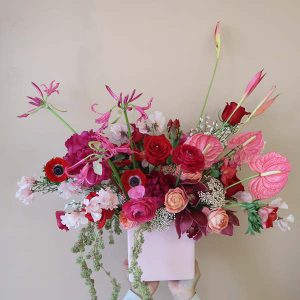 Pink and red floral arrangement in a pale pink box