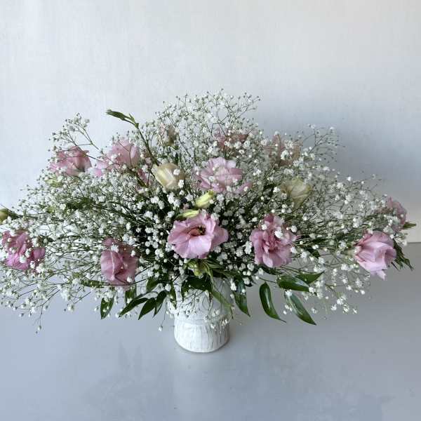 Pink and white floral arrangement in a white vase