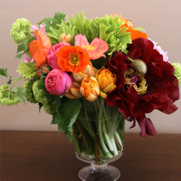 Colorful bouquet of mixed flowers in a clear glass vase