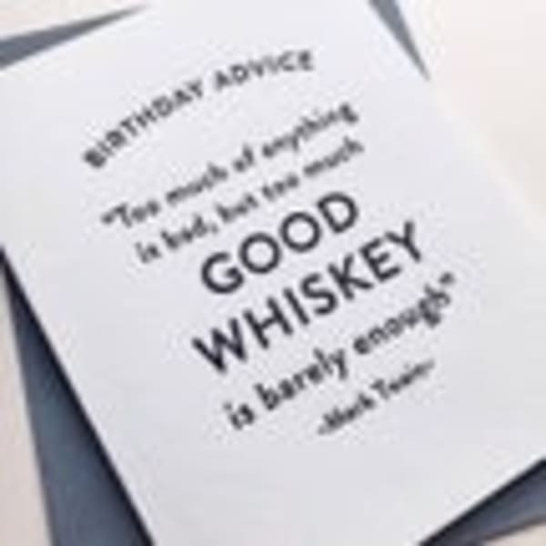 A greeting card with the words "GOOD WHISKEY" on the cover