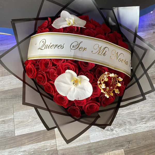 Heart-shaped bouquet of red roses with white orchids and a decorative ribbon
