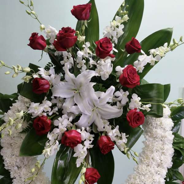 Standing floral wreath with red roses and white lilies