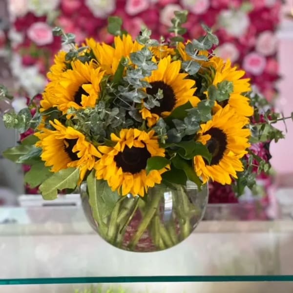 Bouquet of yellow sunflowers in a clear glass vase