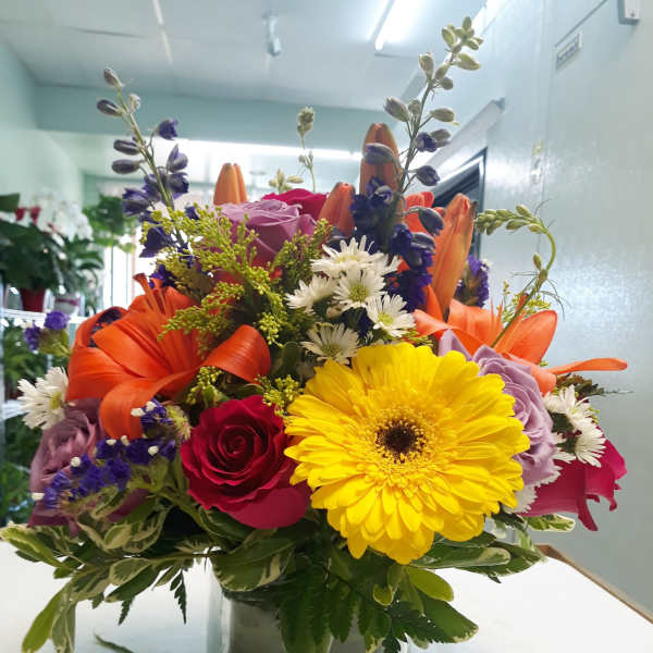 Colorful mixed bouquet in a square glass vase