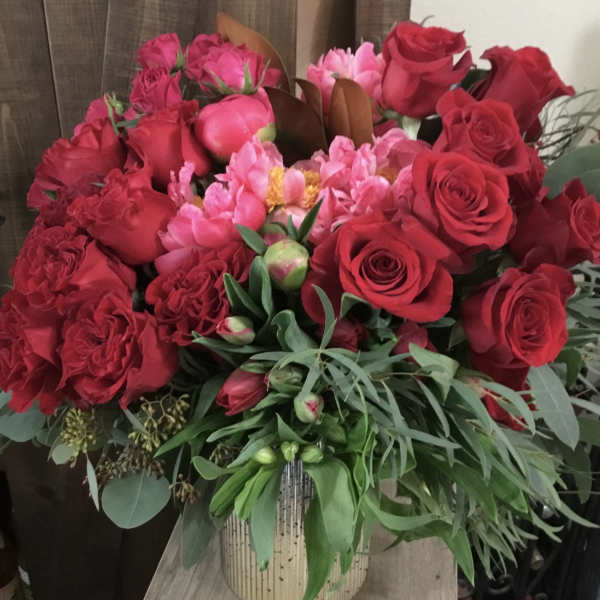 Bouquet of red and pink roses in a striped vase