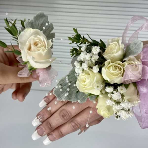 Cream rose corsage and boutonniere with pink ribbon and baby's breath