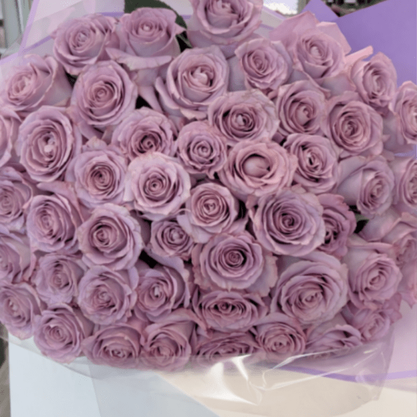 Bouquet of lavender roses wrapped in pale purple paper