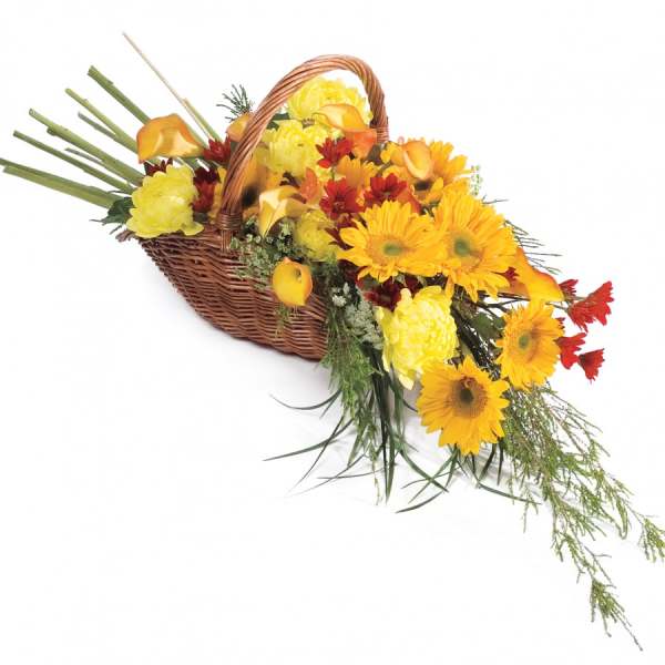 Basket arrangement with yellow and orange flowers and red accents