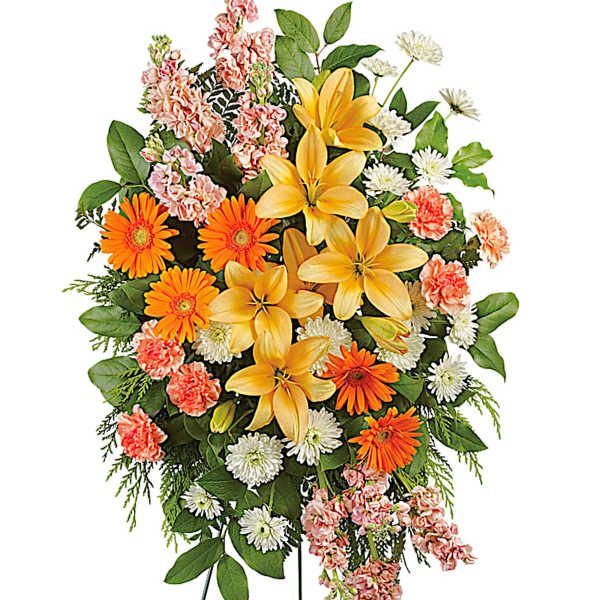 Standing floral spray with yellow lilies, orange daisies, and pink carnations