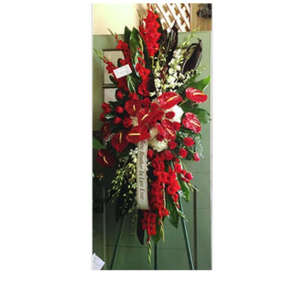 Tall red floral standing spray on an easel