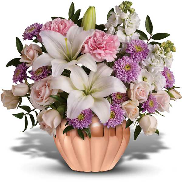 Pink and white floral arrangement in a peach vase