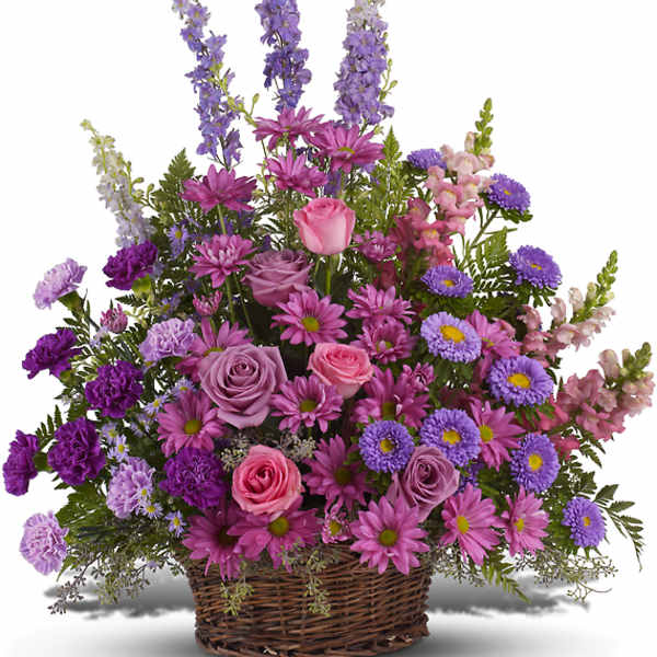 Basket arrangement of pink and purple flowers with tall lavender spikes