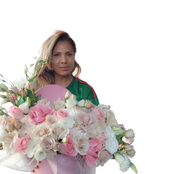 Woman holding a large pink hatbox of pale pink and white roses